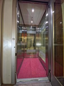 un corridoio con un tappeto rosso in un ascensore di Hotel Chalet d'Oulx a Oulx