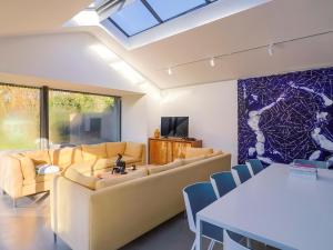 a living room with a couch and a table at Bredy Cottages in Bridport