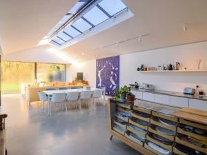 a kitchen and dining room with a table and chairs at Bredy Cottages in Bridport