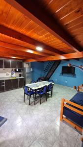 a dining room with a table and blue chairs at El Pilo in Centenario +10 photos