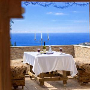 a table with a bottle of wine and two glasses at Villa Sea La Vie in Utjeha