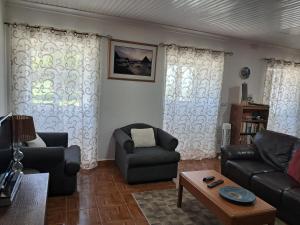 a living room with a couch and two chairs at Casa de Santa Catarina in Cabo da Praia