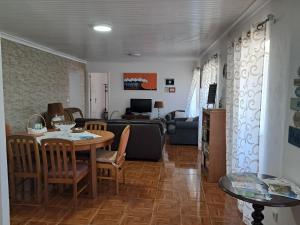a living room with a dining table and a living room at Casa de Santa Catarina in Cabo da Praia