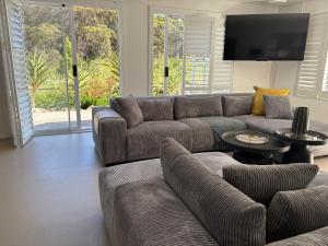 a living room with a couch and a flat screen tv at Providence in Hermanus