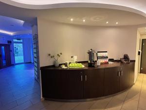 a kitchen with a counter in the middle of a room at Hotel Phönix in Bad Füssing +5 photos