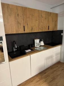 a kitchen with white cabinets and a counter top at Berlińska 43 in Jelenia Góra