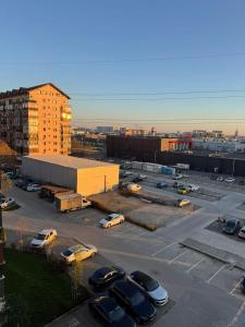 a parking lot with cars parked in a parking lot at Avangarde City bloc 7 in Roşu