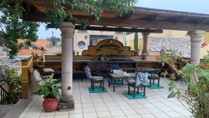 a patio with chairs and a table and a bar at Casa Díaz in San Miguel de Allende