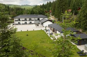 an aerial view of a building with a large yard at Casa de Vacanta Magherus in Topliţa