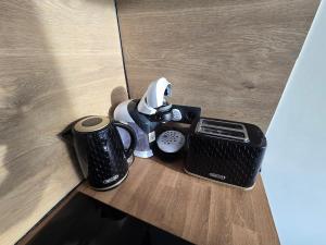 a coffee maker and a toaster on a table at Ohuta-Barn Vendégház in Parád