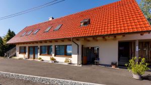 a building with an orange tile roof at Samenkönig Pschait Handels GmbH in Gamlitz
