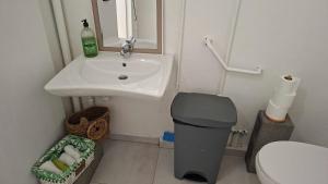 a small bathroom with a sink and a toilet at Comme à la maison! Le Moule in Le Moule