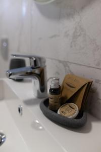 a bathroom sink with a bottle of iodine on it at Casa de Vacanta Magherus in Topliţa +129 photos