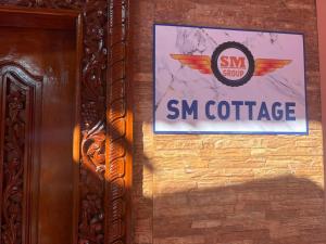 a sign for smm coffee hanging on a wall at SM Cottage in Mangalore +4 photos