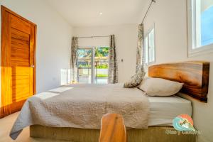 a bedroom with a large bed with a wooden headboard at Villa Moka 2 in Taxisco +35 photos
