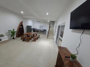 a living room with a table and a flat screen tv at Villa Moka 2 in Taxisco