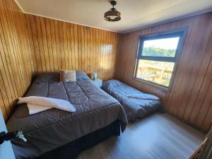 En eller flere senge i et værelse på Cabaña y Tinaja Playa Chaiguao