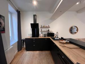 a kitchen with a wooden counter top in a room at Charmant duplex in Moulins