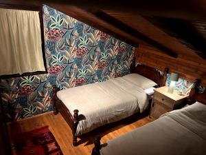 a bedroom with two beds and a wall with a mural at Wellness house Svjetlost in Jahorina