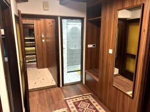 an empty hallway with a glass door in a house at Wellness house Svjetlost in Jahorina +37 photos
