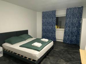 a bedroom with a bed and a window with curtains at Alfa Hotel Frankfurt in Frankfurt +5 photos