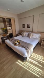 a large bed with a tray of fruit on top of it at DAKAR HOTEL in Mendoza