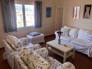 a living room with a couch and a table at Tranquility House Astros in Paralio Astros