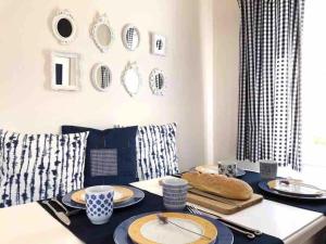 a dining room with a table with plates on it at Tranquility House Astros in Paralio Astros