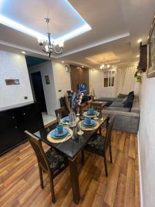 a dining room and living room with a table and chairs at Sweet appartement in Tangier