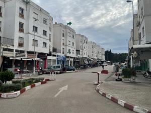 an empty street in a city with buildings at Sweet appartement in Tangier