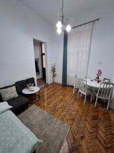 a living room with a couch and a table at Art Nouveau Aparthotel in Oradea