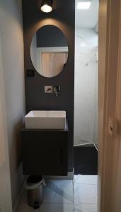 a bathroom with a sink and a mirror at Le Patio Spa in Chartres +43 photos
