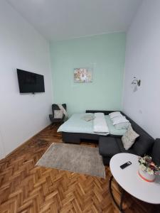 a living room with a couch and a table at Art Nouveau Aparthotel in Oradea