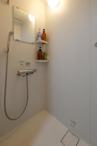 a bathroom with a shower and a sink and a mirror at Tokyo My Home Private Room for 3 Guests near Shinjuku Shared Facilities in Tokyo