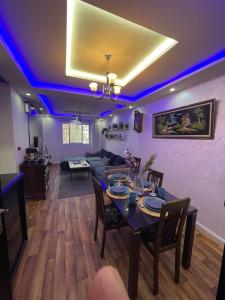 a living room with purple lights on the ceiling at Sweet appartement in Tangier +16 photos