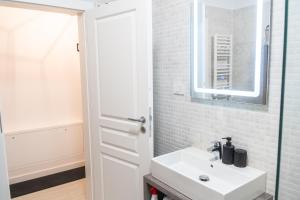 a bathroom with a sink and a mirror at Royal Blue Iasi in Iaşi