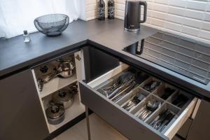 a kitchen with a black counter top with an open drawer at Royal Blue Iasi in Iaşi