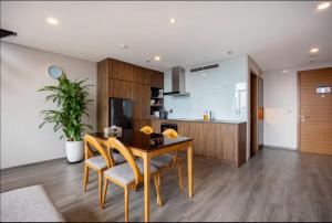 a kitchen and dining room with a table and chairs at Solari 15F Duplex Suite with Nhat Tan Bridge View in Hanoi