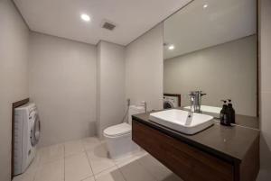a bathroom with a sink and a toilet at Solari 15F Duplex Suite with Nhat Tan Bridge View in Hanoi +7 photos
