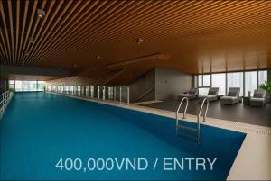 a large swimming pool in a building with a lobby at Solari 15F Duplex Suite with Nhat Tan Bridge View in Hanoi
