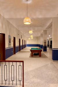 a room with a pool table in the middle of it at The Pavilion at Riverside Park in Kāundia