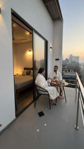 two people sitting at a table on a balcony at Lucky Wave Beach Resort in Colombo +30 photos