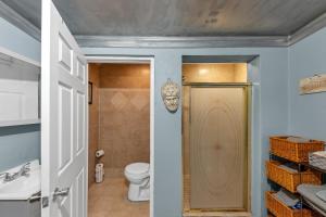 a bathroom with a toilet and a sink and a door at Charming Atlanta Home in Atlanta