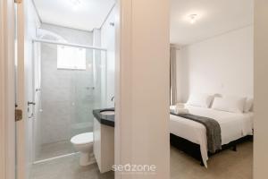 a bathroom with a bed and a toilet and a shower at Apartment 100m from Tabuleiro Beachfront CIR0102 in Barra Velha +12 photos