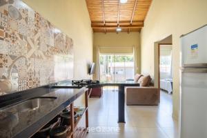a kitchen with a sink and a counter top at 2-Bedroom House with Barbecue Area WIL0012 in Imbituba
