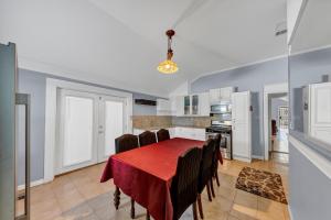 a dining room with a red table and chairs at Charming Atlanta Home in Atlanta