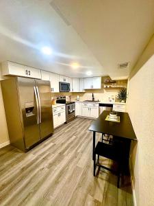 a kitchen with a stainless steel refrigerator and a table at Private Residence Below Basement in Thornton