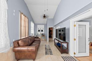 a living room with a brown leather couch at Charming Atlanta Home in Atlanta