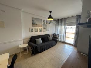 a living room with a couch and a table at Oropesa del Mar Valparaiso Marina Dór in Oropesa del Mar