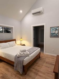 a bedroom with a bed and a air conditioner at Vineyard Room @ Boulder Mountain View Barn in Twin Mountain
